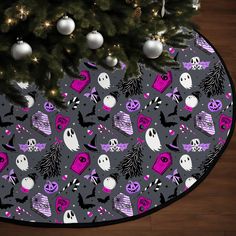 a christmas tree skirt with halloween decorations on it