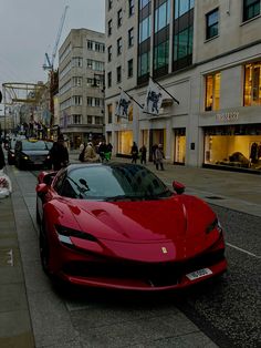 a red sports car is parked on the street