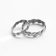 two silver rings sitting on top of each other