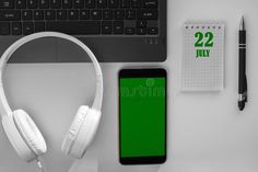 Calendar date on a light background of a desktop and a phone with a green screen. July 22 is the twenty-second day of the month royalty free stock p Calendar Date, 12 December, Light Background, December 12, Icon Set Vector, Green Screen, Lights Background, Note Pad