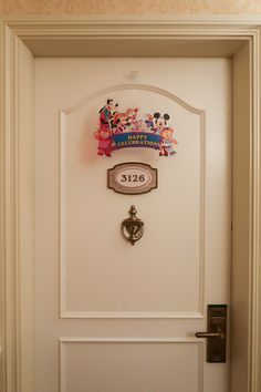 the door is open and there are mickey mouse magnets on the wall above it