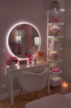 a white desk topped with a mirror next to a chair and table covered in pink flowers