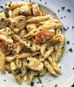 a white plate topped with pasta and chicken