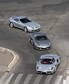 three silver sports cars driving on a race track