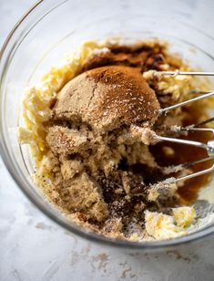 a mixing bowl filled with ingredients to make chocolate ice cream pies on a white surface