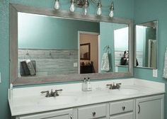 a bathroom with two sinks and a large mirror