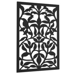 an intricate metal panel with leaves and flowers in black, on a white wall background