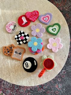 several different types of appliques on a table with a cup and saucer