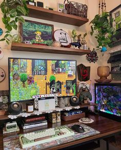 there is a desk with many items on it and some plants in the back ground