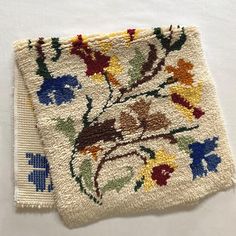 two white rugs with colorful flowers on them