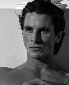 a black and white photo of a shirtless man