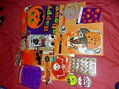 various halloween stickers and magnets on a bed with a red sheet in the background