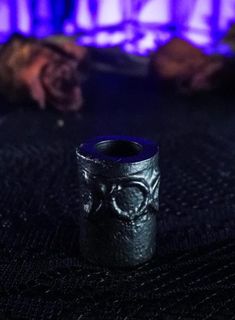 an object is sitting on the floor in front of a fire place with purple lights