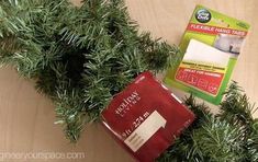 a package of hand soap sitting on top of a christmas tree branch next to a box of tissues