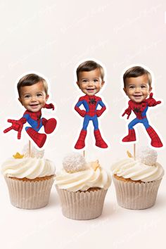 three cupcakes with spiderman cutouts on them