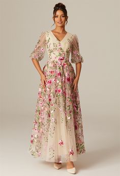 a woman wearing a dress with flowers on it