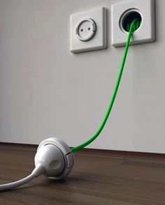 an electrical outlet plugged into a wall with a green cord attached to the outlet