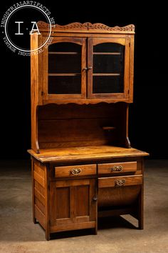 an old wooden desk with drawers and cupboards on it's sides, in front of a black background