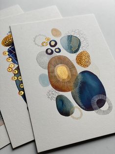 three cards with different designs on them, one is blue and the other is gold