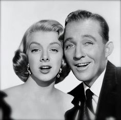 an old black and white photo of a man and woman posing for the camera together