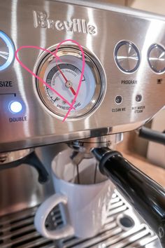 a coffee machine with a heart on the front and side panel showing where it is located