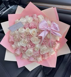 a bouquet of flowers in the back seat of a car with a name tag on it