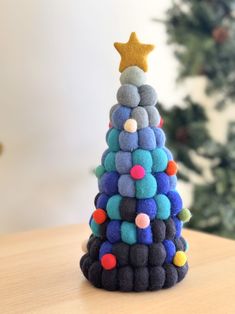 a small felt christmas tree on a table