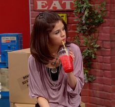 a young woman drinking a smoothie from a cup