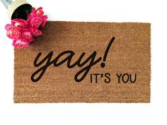 a door mat with the words yay it's you on it and pink flowers