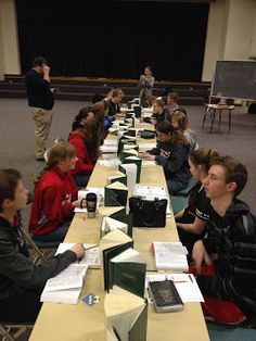 a group of people sitting at long tables