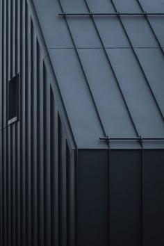 an airplane flying over the top of a building with metal bars on it's sides