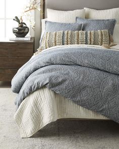 a bed with white and brown bedspread in a room