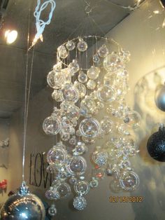 a chandelier hanging from the ceiling in a room with ornaments and lights on it