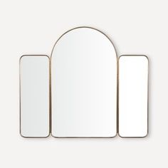 an oval mirror and two rectangular mirrors against a white wall