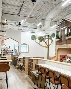 the interior of a furniture store with lots of counter space and chairs in front of it