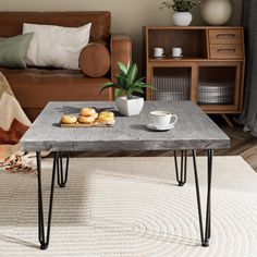 a coffee table sitting on top of a rug in a living room