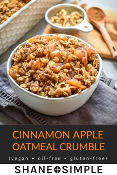 cinnamon apple oatmeal crumble in a white bowl with spoons next to it