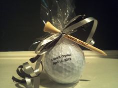 a golf ball wrapped in plastic and tied to a ribbon