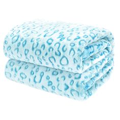 two blue leopard print blankets stacked on top of each other