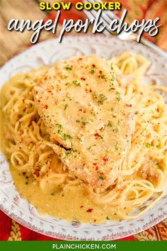 a white plate topped with pasta covered in sauce and chicken breast on top of it