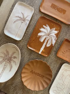 assorted ceramic plates with palm trees on them