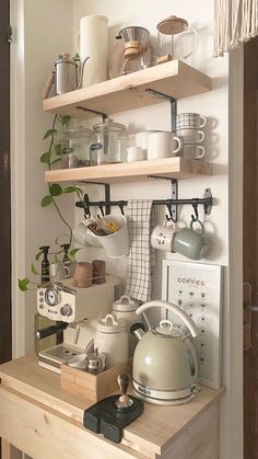 a kitchen shelf filled with pots and pans