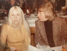 two women sitting at a table in a restaurant