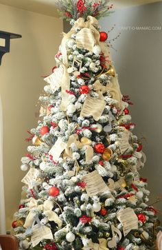 a decorated christmas tree with red, white and gold ornaments