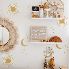 the wall is decorated with gold stars and moon decals on it, along with decorative accessories