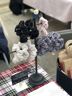 there are many crocheted items on the table and one is black, white, pink, blue