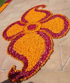 a mickey mouse made out of flowers on the ground