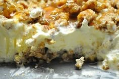 a close up of a dessert with nuts and cheese