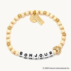 As Emily would say, A little ‘bonjour’ goes a long way". Channel her cheerful personality with the return of our beloved “Bonjour” bracelet featuring a quintessentially Parisian croissant casted bead. Add a touch of Parisian charm to your style and make every day more magnifique. Connect your bracelet for exclusive access to Nice Nation's online community. Enjoy early access, exclusive offers, and connect with fellow members. Follow your Word's journey as you pass it on to someone who needs it m Little Words Project, Erin Gray, Paris Bracelet, Emily In Paris, Sneaker Heels, Online Community, Earring Necklace, Handbag Accessories, Bath And Body