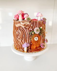 a cake decorated with flowers and mushrooms on a plate